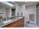 Modern bathroom features double sinks, granite countertops, and a tiled shower with a skylight above at 13959 W Cedar Pl, Golden, CO 80401