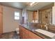 Bathroom featuring double sinks, a large mirror, and a separate shower, offering convenience and style at 13959 W Cedar Pl, Golden, CO 80401