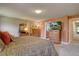 Spacious bedroom with TV, dressers, and access to the bathroom, providing a comfortable retreat at 13959 W Cedar Pl, Golden, CO 80401
