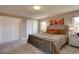 Cozy bedroom features a comfortable bed, closet, and warm decor with colorful modern art at 13959 W Cedar Pl, Golden, CO 80401