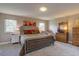 Cozy bedroom features a large bed, dresser, bedside tables, and natural light from two windows at 13959 W Cedar Pl, Golden, CO 80401