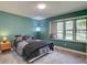 Well-lit bedroom with a large window, offering a peaceful and inviting retreat with green walls at 13959 W Cedar Pl, Golden, CO 80401