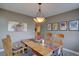 Inviting dining area with a wooden table, charming decor, and plenty of natural light at 13959 W Cedar Pl, Golden, CO 80401