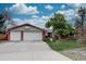 Inviting front exterior features a brick facade, double garage, basketball hoop and mature trees at 13959 W Cedar Pl, Golden, CO 80401