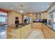 Bright kitchen featuring a large island with a cooktop, stainless steel appliances, and plenty of cabinet space at 13959 W Cedar Pl, Golden, CO 80401