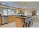 Beautiful kitchen showcasing stone countertops, a large window, bar stool seating, and hardwood floors at 13959 W Cedar Pl, Golden, CO 80401