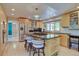 Modern kitchen with sleek countertops, stainless steel appliances, island with seating, and ample cabinet space at 13959 W Cedar Pl, Golden, CO 80401