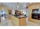 Well-equipped kitchen island with a gas cooktop, adjacent to the dining area and cozy living room with fireplace at 13959 W Cedar Pl, Golden, CO 80401