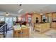 Open-concept view highlighting the kitchen with island cooktop, dining area, and adjacent living room at 13959 W Cedar Pl, Golden, CO 80401
