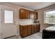 Functional laundry room featuring ample cabinet space, a utility sink, and natural light from a nearby window at 13959 W Cedar Pl, Golden, CO 80401