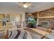 Inviting living room featuring a brick fireplace, built-in bookshelves, and seamless flow to the kitchen at 13959 W Cedar Pl, Golden, CO 80401