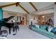 Stylish living area with a grand piano, vaulted ceiling, and seamless transition to the dining area at 13959 W Cedar Pl, Golden, CO 80401
