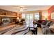 Comfortable living room with a cozy fireplace and sliding glass doors leading to an outdoor balcony at 13959 W Cedar Pl, Golden, CO 80401