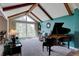 Bright and airy living room with vaulted ceilings, large windows, and an elegant grand piano at 13959 W Cedar Pl, Golden, CO 80401