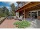 Relaxing outdoor patio with brick flooring, seating, and views from the raised deck above at 13959 W Cedar Pl, Golden, CO 80401