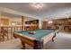 Large recreation room featuring a pool table, a brick fireplace, and a wet bar, perfect for entertaining at 13959 W Cedar Pl, Golden, CO 80401