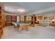 Expansive recreation room with a pool table and an adjacent seating area perfect for entertaining or relaxation at 13959 W Cedar Pl, Golden, CO 80401