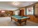 Spacious recreation room featuring a classic pool table and a cozy fireplace for entertaining guests at 13959 W Cedar Pl, Golden, CO 80401
