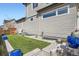 The backyard of the house featuring artificial grass, rockscaping and a comfortable outdoor seating area at 6353 N Fulton St, Denver, CO 80238