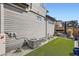 The backyard of the house featuring artificial grass, rockscaping and a comfortable outdoor seating area at 6353 N Fulton St, Denver, CO 80238