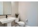 Cozy bathroom with pedestal sink, modern fixtures and decorative succulent at 6353 N Fulton St, Denver, CO 80238