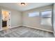 This bedroom has neutral paint, carpet flooring, and natural light at 6353 N Fulton St, Denver, CO 80238