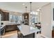 Bright kitchen showcases a large center island, modern appliances, and seamless flow to the adjacent dining area at 6353 N Fulton St, Denver, CO 80238