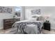 Comfortable bedroom featuring a queen bed, soft gray linens, and neutral wall decor at 3580 W 62Nd Pl, Denver, CO 80221