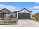 Exterior features a detached garage with backyard view at 3580 W 62Nd Pl, Denver, CO 80221