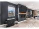 Living room featuring dark accent walls, a fireplace with a mounted TV, and an arcade game at 3580 W 62Nd Pl, Denver, CO 80221