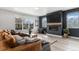 Cozy living room with modern decor, a fireplace, and large windows for natural light at 3580 W 62Nd Pl, Denver, CO 80221