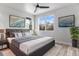 Comfortable primary bedroom with ample natural light, stylish decor, and a ceiling fan at 3580 W 62Nd Pl, Denver, CO 80221