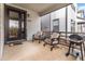 Covered porch with outdoor furniture, barbecue, and views of the surrounding neighborhood at 3580 W 62Nd Pl, Denver, CO 80221