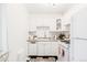 Charming kitchen boasts white cabinets and modern appliances at 1101 Bellaire St # 204, Denver, CO 80220