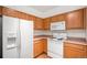 Modern kitchen featuring wood cabinets and stainless steel appliances at 14700 E 104Th Ave # 1701, Commerce City, CO 80022