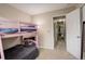 Bright bedroom with pink bunk beds adjacent to a hallway featuring carpeted flooring at 3518 S Depew St # 102, Lakewood, CO 80235