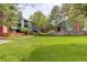 Scenic view of community green space surrounded by mature trees and residential buildings with private balconies at 3518 S Depew St # 102, Lakewood, CO 80235