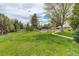 Expansive community green space with mature trees, picnic tables, and walking path, perfect for outdoor enjoyment at 3518 S Depew St # 102, Lakewood, CO 80235