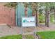 Sign for the Tall Pines community, highlighting its covenant-controlled environment and green landscape at 3518 S Depew St # 102, Lakewood, CO 80235
