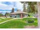View of the side of the pool house showing a well-kept lawn and landscaping at 3518 S Depew St # 102, Lakewood, CO 80235