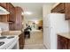 Open floor plan showing the kitchen that leads to the living area with a stone fireplace at 3518 S Depew St # 102, Lakewood, CO 80235
