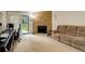 A cozy living room with a stone fireplace and a sliding glass door that leads to the outside at 3518 S Depew St # 102, Lakewood, CO 80235