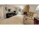 Living room featuring a comfortable sofa, workspace, and a stone fireplace at 3518 S Depew St # 102, Lakewood, CO 80235