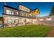 Expansive backyard featuring a well-manicured lawn, a covered patio, and an outdoor kitchen area at 4520 W Moncrieff Pl, Denver, CO 80212