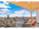 Balcony with views, wood ceiling, and outdoor furniture at 4520 W Moncrieff Pl, Denver, CO 80212