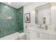 Beautifully designed bathroom with green tiled shower and modern fixtures at 4520 W Moncrieff Pl, Denver, CO 80212