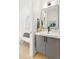 Modern bathroom with sleek vanity, dark fixtures, and decorative mirror at 4520 W Moncrieff Pl, Denver, CO 80212