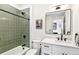Stylish bathroom featuring a tiled shower, modern vanity, and contemporary fixtures at 4520 W Moncrieff Pl, Denver, CO 80212