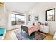 Cozy bedroom with large windows, bright decor, and city views, creating a charming space at 4520 W Moncrieff Pl, Denver, CO 80212