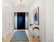 Bright foyer with light wood floors, modern lighting, and stylish decor at 4520 W Moncrieff Pl, Denver, CO 80212